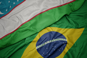 waving colorful flag of brazil and national flag of uzbekistan.