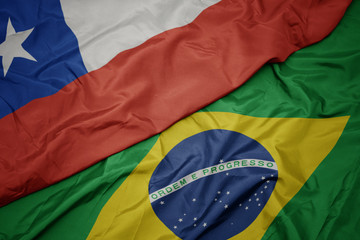 waving colorful flag of brazil and national flag of chile.