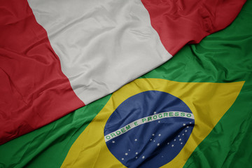 waving colorful flag of brazil and national flag of peru.