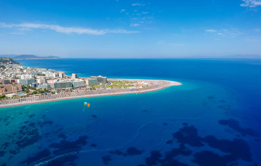 Fototapeta na wymiar Aerial birds eye view drone photo of Elli beach on Rhodes city island, Dodecanese, Greece. Panorama with nice sand, lagoon and clear blue water. Famous tourist destination in South Europe