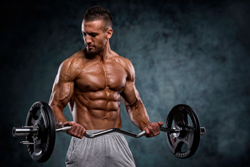 Fototapeta na wymiar Muscular Men Lifting Weights. Studio Shot