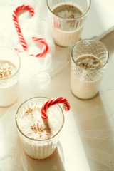 Traditional winter delicious homemade Christmas cocktail eggnog with milk, rum,cinnamon and nutmeg