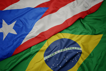 waving colorful flag of brazil and national flag of puerto rico.