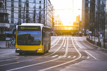 Yellow public transportation bus passing by the city of Berlin Germany