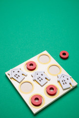 tic tac toe using house shape on green background- real estate strategy