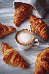 Croissants and a cup of coffee on a table
