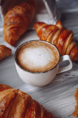 Croissants and a cup of coffee on a table