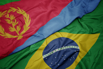 waving colorful flag of brazil and national flag of eritrea.