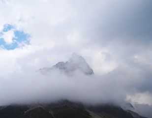 The Pale di San Martino, Some of the most famous peaks of the Dolomites that emerge from the clouds of Trentino, near the town of San Martino di Castrozza, Italy - August 2019.