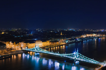 Fototapeta na wymiar Night view of Budapest. Panorama cityscape of famous tourist destination with Danube and bridges. Travel illuminated landscape in Hungary, Europe.