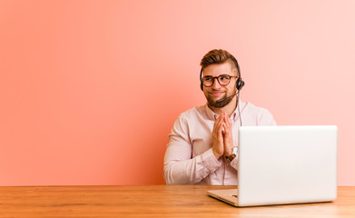 Young man working in a call center making up plan in mind, setting up an idea.