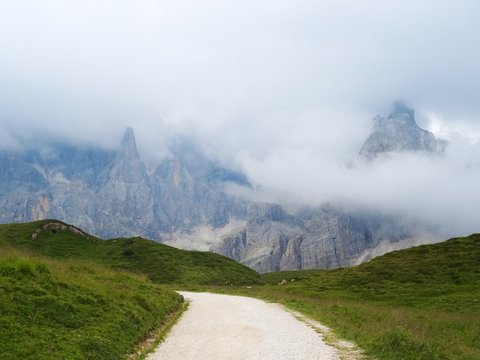 The Pale di San Martino, Some of the most famous peaks of the Dolomites that emerge from the clouds of Trentino, near the town of San Martino di Castrozza, Italy - August 2019.
