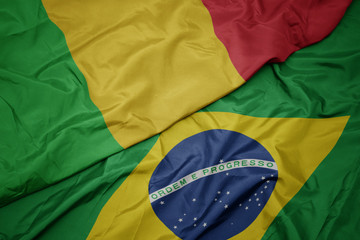 waving colorful flag of brazil and national flag of mali.