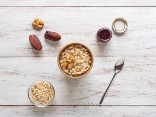 Oatmeal porridge with dates in a cardboard cup. Healthy food and diet concept.