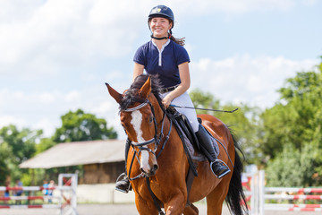 Young female horse rider on equestrian sport event