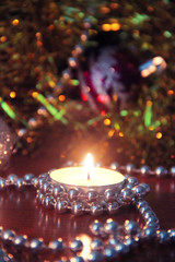 Christmas burning candles and tree decorations in New Years decor