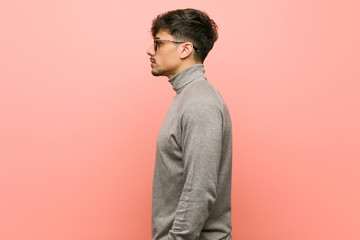 Young smart student man gazing left, sideways pose.