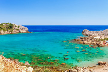Fototapeta premium Sea skyview landscape photo Ladiko bay near Anthony Quinn bay on Rhodes island, Dodecanese, Greece. Panorama with nice sand beach and clear blue water. Famous tourist destination in South Europe