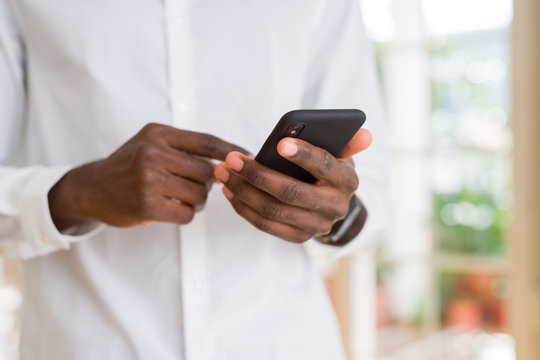 Close up of african man hands using smarpthone
