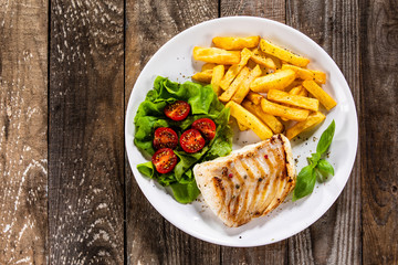 Fried cod loin with french fries and vegetables