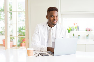 Handsome african proffesional man working using laptop for the business smiling cheerful