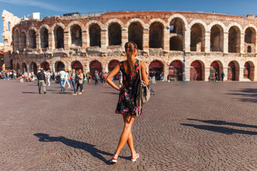 Toirust woman in Verona historical center on square near Arena Verona, Roman amphitheater. Traveler...