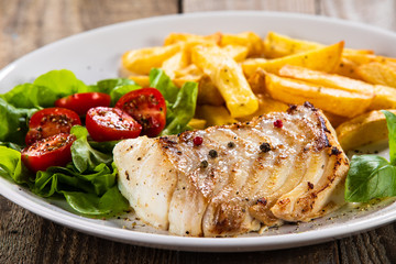 Fried cod loin with french fries and vegetables
