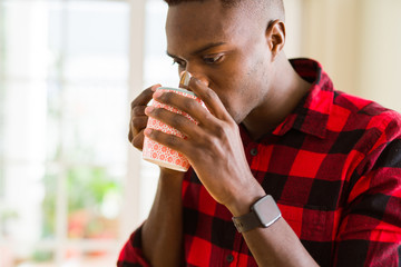 Young african american man drinking a cup of coffee