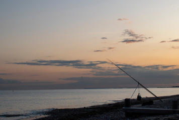 Fishing on West Beach Littlehampton in the evening during a beautiful sunset.