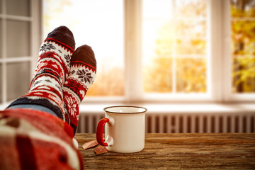 Autumn window and woman legs with socks. Free space for your decoration. 