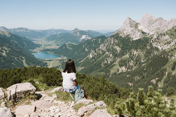 Hiker at Tannheim valley with view on the lake Haldensee from the mountain Neunerköpfle - Hiking in beautiful landscape scneery of Alps, Tirol, Austria, Europe