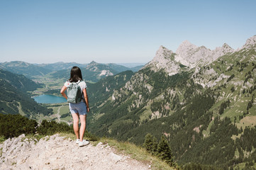 Naklejka premium Hiker at Tannheim valley with view on the lake Haldensee from the mountain Neunerköpfle - Hiking in beautiful landscape scneery of Alps, Tirol, Austria, Europe