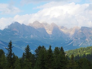 Some peaks of the Dolomites immersed in the nature of the Val di Fassa, near the town of Canaze, Italy - August 2019.
