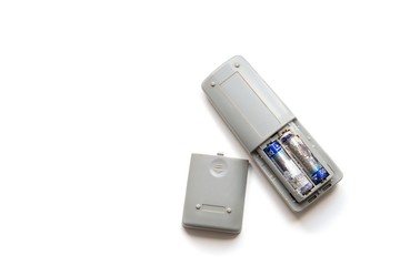 Remote control with old battery leak on white background. Hazardous waste concept