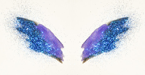 Blue glitter on abstract purple watercolor wings, beautiful shiny feathers