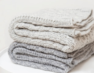 A stack of knitted handmade plaids