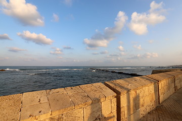 stone wall of an ancient fortress in the city of Acre on the shores of the Mediterranean Sea in the north of Israel