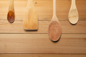Wooden spoons and stirrer on wooden table. Kitchen and cooking concept.