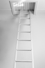 White old staircase to a closed wooden attic