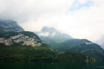 Mountains covered in forests, over the lake