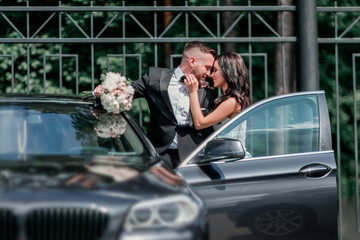 Fototapeta na wymiar close up. bride and groom standing near the car