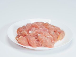 Fresh chicken tenderloin in white plate