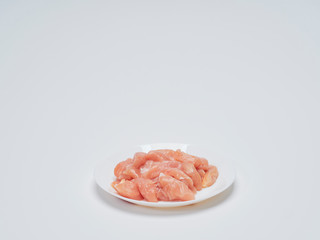 Fresh chicken tenderloin in white plate