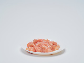 Fresh chicken tenderloin in white plate