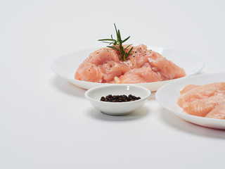 Fresh chicken tenderloin in white plate