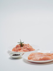 Fresh chicken tenderloin with wooden board, knife.