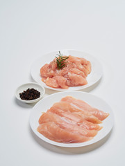 Fresh chicken tenderloin with wooden board, knife.