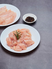 Fresh chicken tenderloin on stone table top