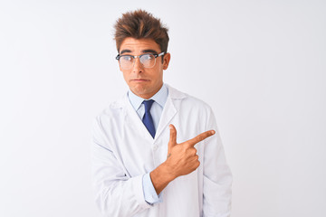 Young handsome sciencist man wearing glasses and coat over isolated white background Pointing aside worried and nervous with forefinger, concerned and surprised expression