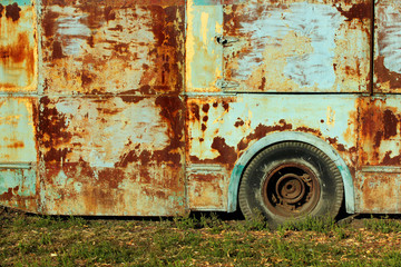 Old rusty bus on green grass